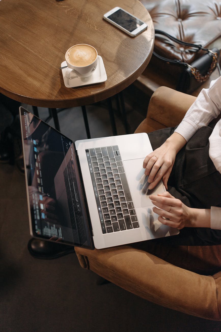 a person scrolling on a laptop